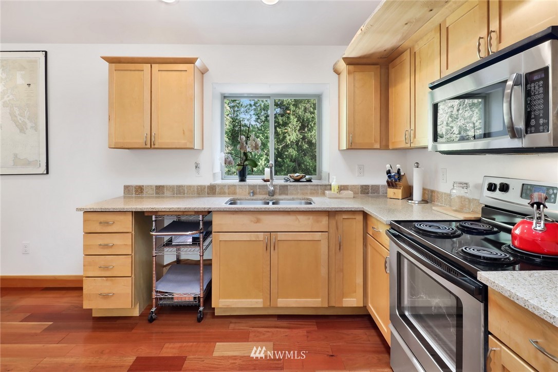 4760 Mission Road Bellingham, WA 98226 - Photo 15 of 40 a kitchen with stainless steel appliances granite countertop a sink stove and cabinets