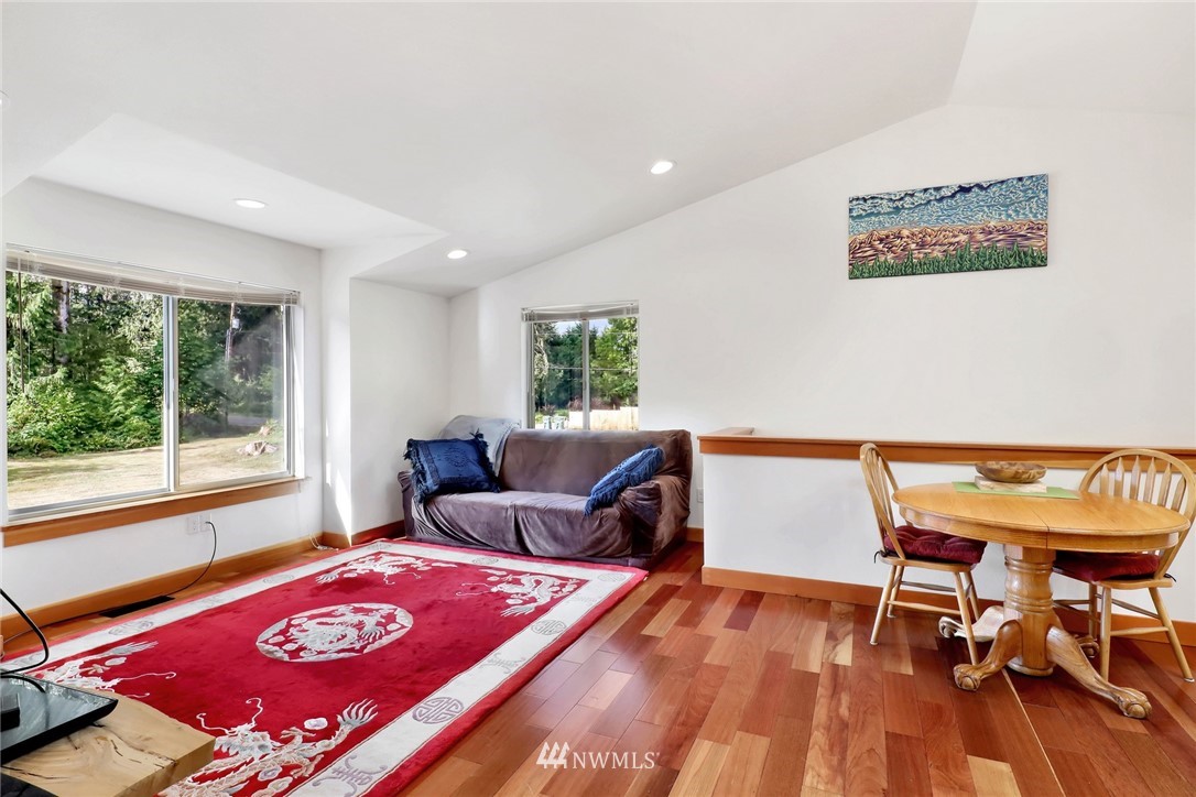 4760 Mission Road Bellingham, WA 98226 - Photo 20 of 40 a living room with furniture a rug and a wooden floor
