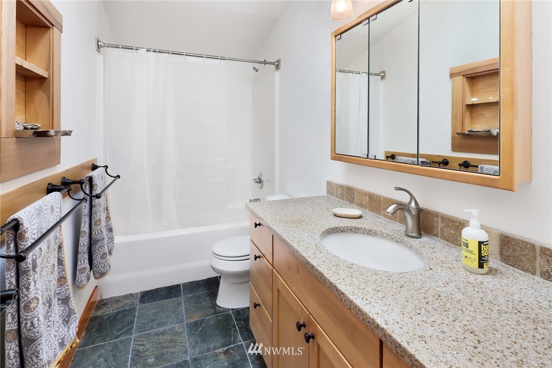 4760 Mission Road Bellingham, WA 98226 - Photo 24 of 40 a bathroom with a granite countertop sink toilet and shower