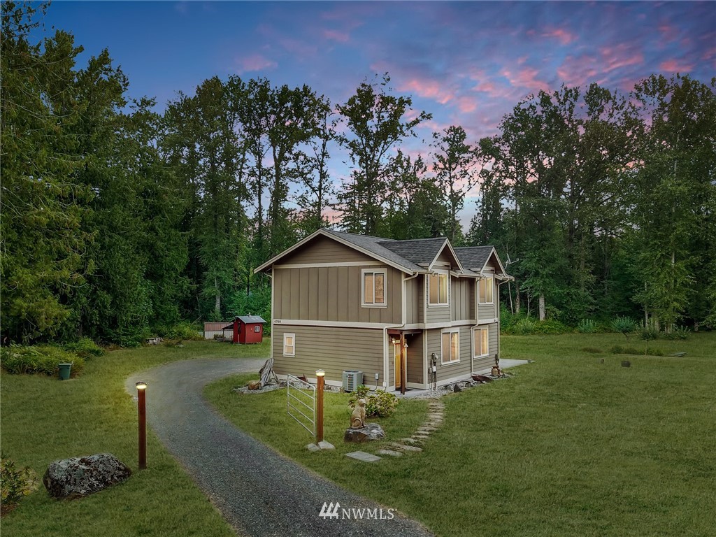 4760 Mission Road Bellingham, WA 98226 - Photo 39 of 40 a view of a house with a big yard and large trees