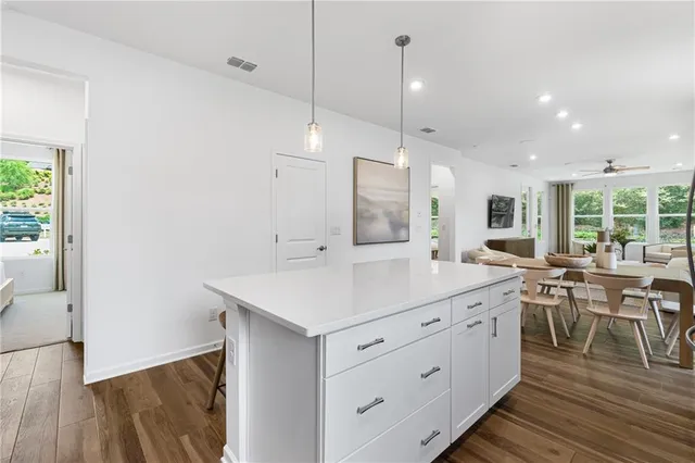 a dining room with furniture and wooden floor