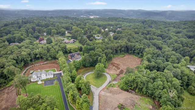 an aerial view of a house with outdoor space and a lake view