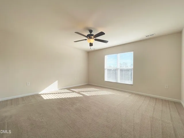 a view of a bedroom with a ceiling fan and a bathroom