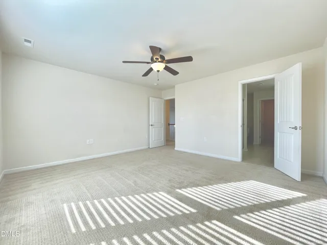 a bathroom with a granite countertop double vanity sink and a mirror