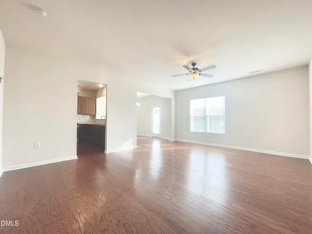 wooden floor in an empty room with a window