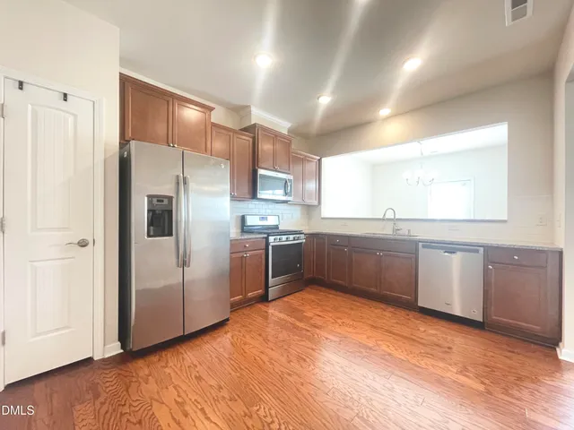 a kitchen with stainless steel appliances a refrigerator and a sink