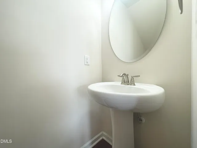 a view of a hallway with a livingroom and entryway