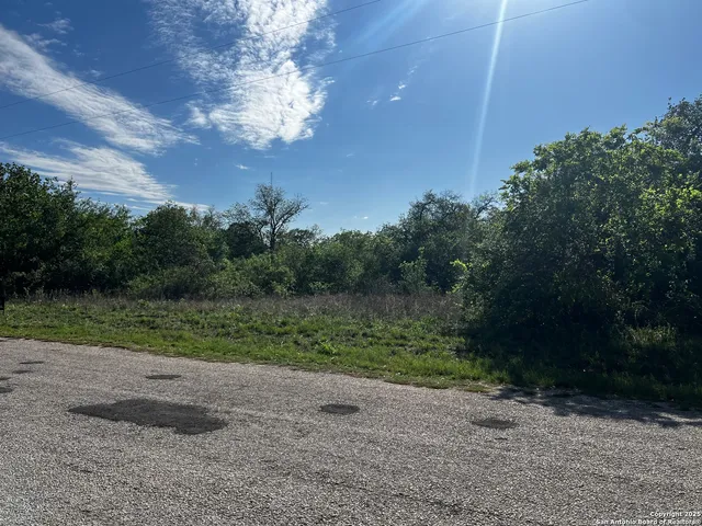 a view of outdoor space with trees all around