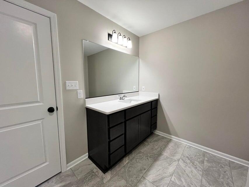 18388 Alexander Avenue Lowell, IN 46356 - Photo 12 of 17 a bathroom with a sink vanity and mirror