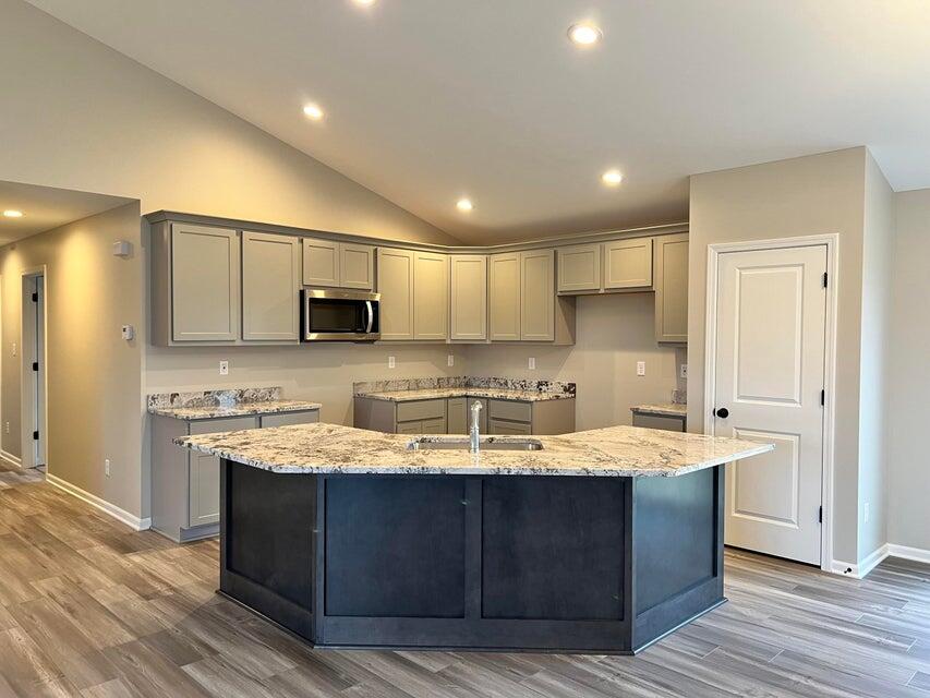 18388 Alexander Avenue Lowell, IN 46356 - Photo 3 of 17 a kitchen with a sink a stove a microwave and cabinets