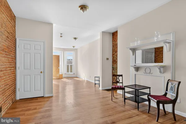 a view of a room with furniture and wooden floor