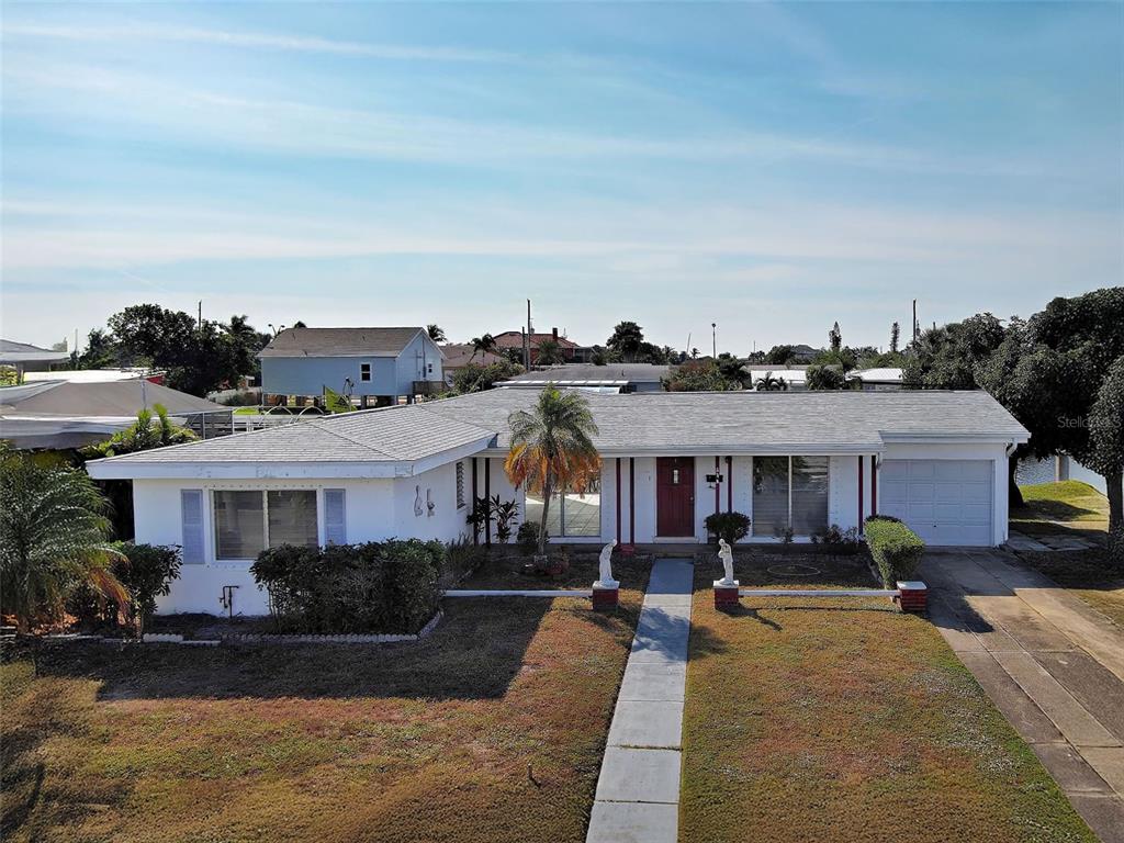 a view of multiple houses with cars parked