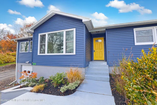 a view of a living room a dining room wooden floor and a window