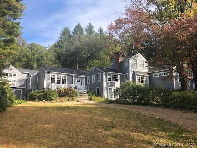 10 Smith Farm Road Weston, CT 06883 - Photo 1 of 1 a front view of a house with a garden and plants