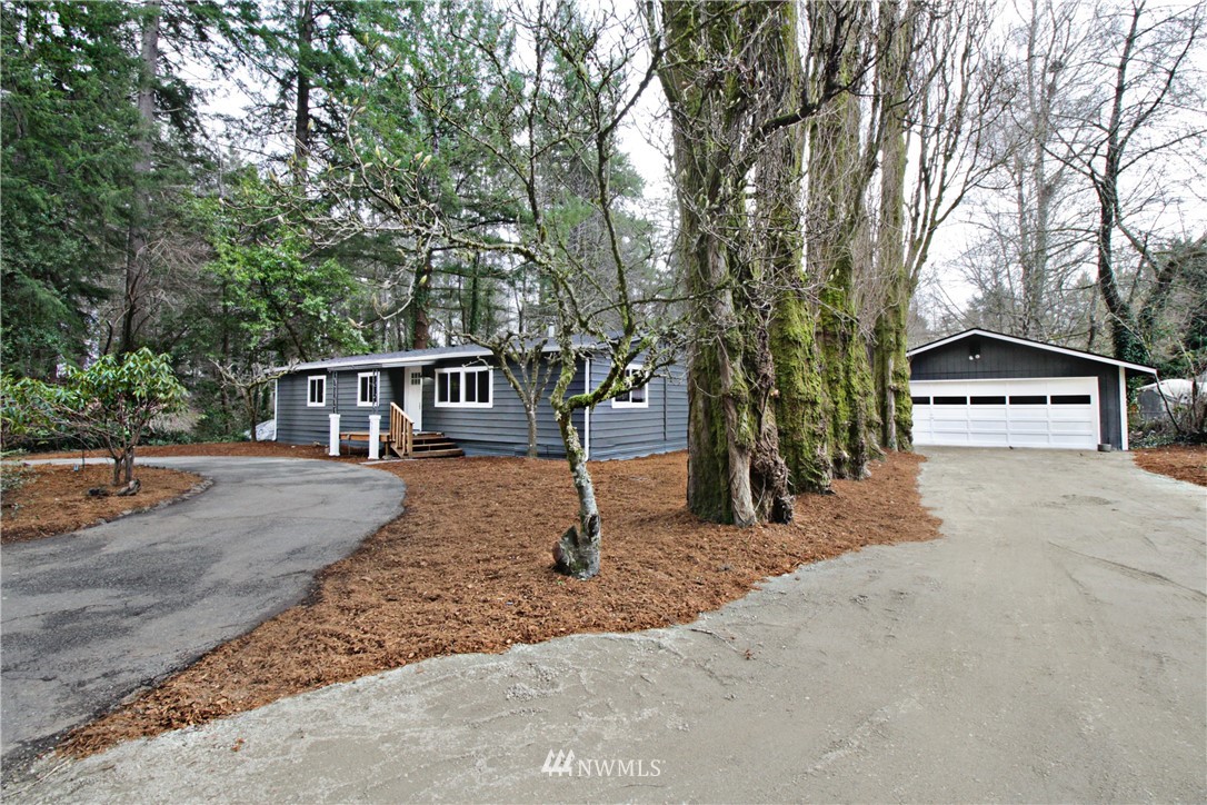 531 Northeast Beck Road Belfair, WA 98528 - Photo 1 of 14 a house with trees in front of it