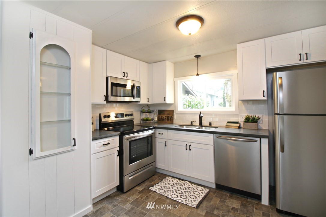531 Northeast Beck Road Belfair, WA 98528 - Photo 5 of 14 a kitchen with granite countertop a refrigerator stove top oven and sink