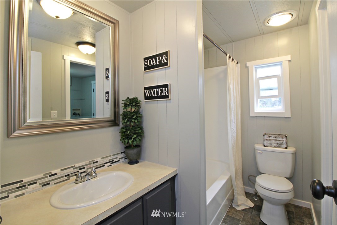 531 Northeast Beck Road Belfair, WA 98528 - Photo 10 of 14 a bathroom with a sink toilet and a mirror