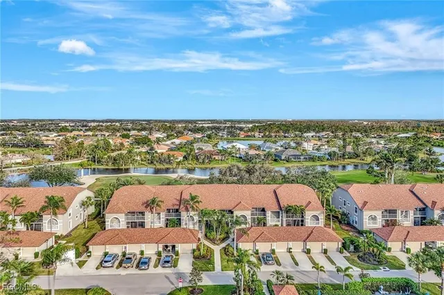 an aerial view of residential houses with city view