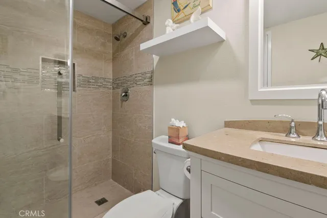 a bathroom with a sink shower and a mirror