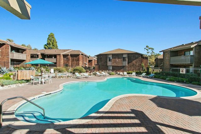 a front view of a house with swimming pool garden and patio