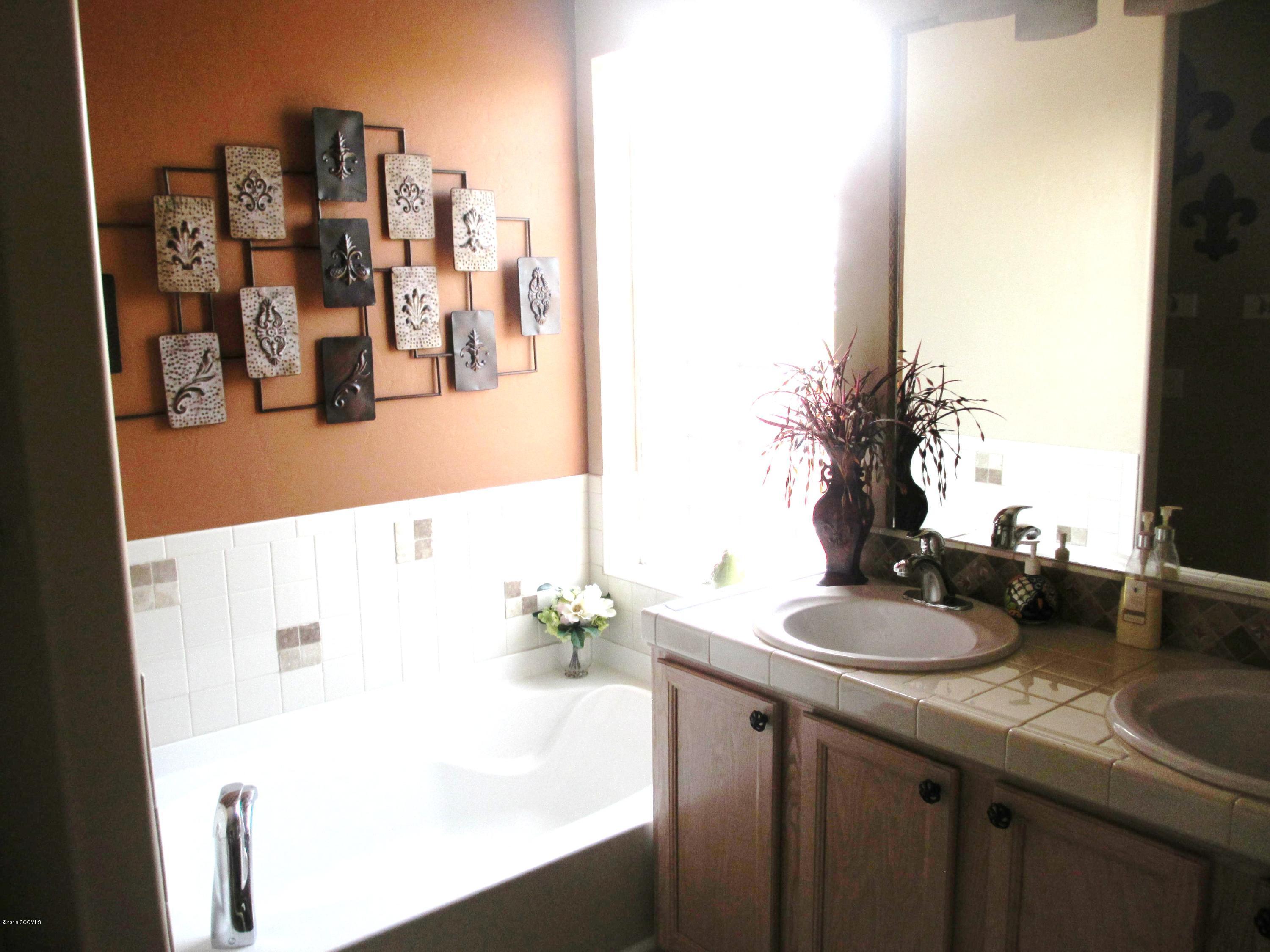 353 Via Bella Donna Rio Rico, AZ 85648 - Photo 8 of 44 a bathroom with a sink and mirror