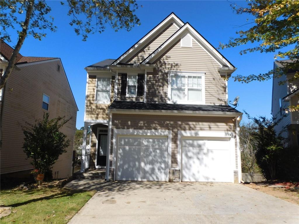566 Pond Lillies Road Southeast Lawrenceville, GA 30045 - Photo 1 of 45 a view of a house with a small yard and potted plants