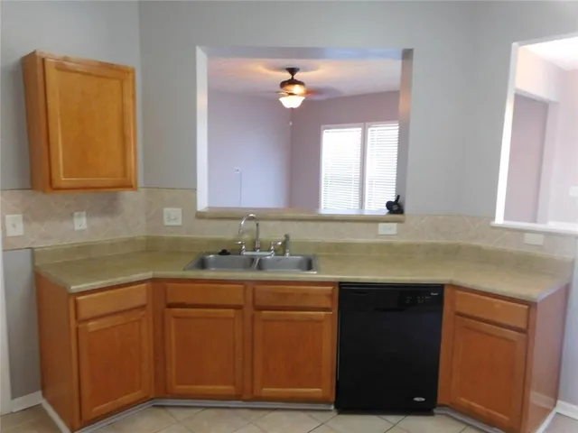 a kitchen with a sink and cabinets