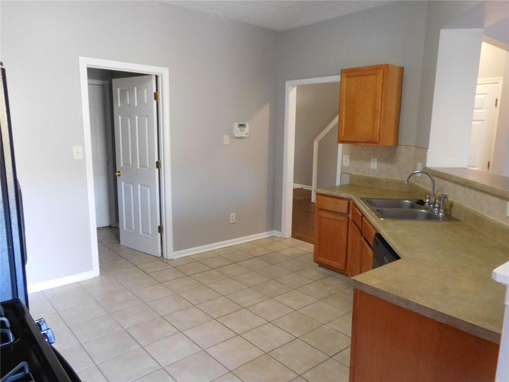 566 Pond Lillies Road Southeast Lawrenceville, GA 30045 - Photo 15 of 45 a kitchen with a sink cabinets and a window