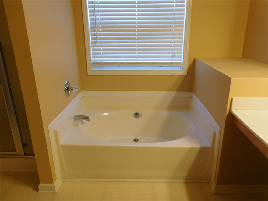 566 Pond Lillies Road Southeast Lawrenceville, GA 30045 - Photo 21 of 45 a bathroom with a tub