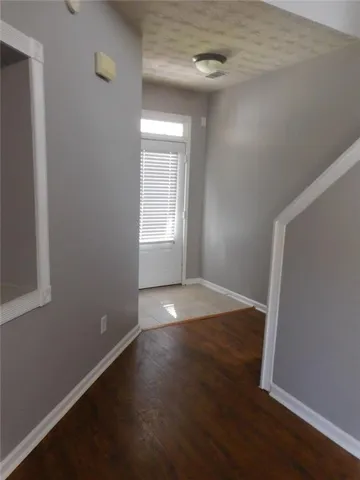 an empty room with a empty space and windows