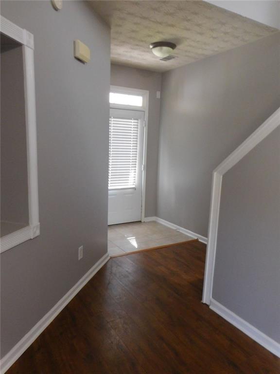 566 Pond Lillies Road Southeast Lawrenceville, GA 30045 - Photo 32 of 45 an empty room with wooden floor and windows