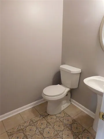 a white toilet sitting next to a shower