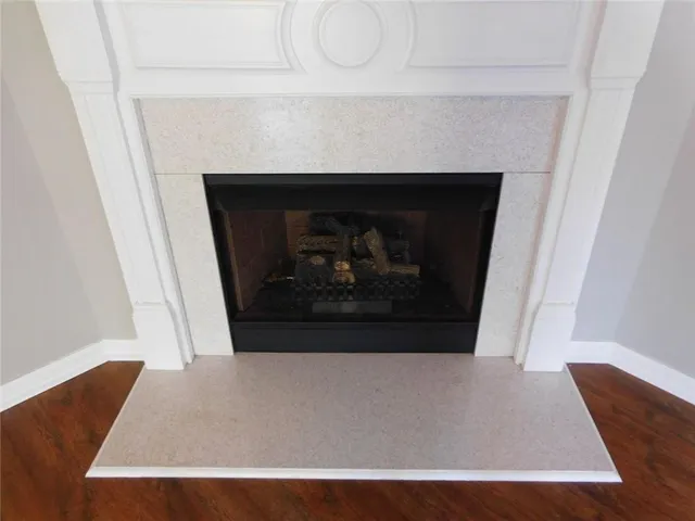 a view of living room with furniture and a fireplace