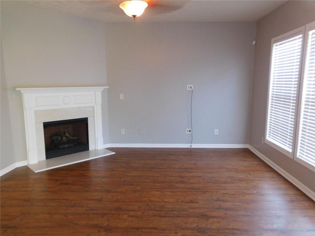 566 Pond Lillies Road Southeast Lawrenceville, GA 30045 - Photo 9 of 45 a view of empty room with wooden floor and fireplace