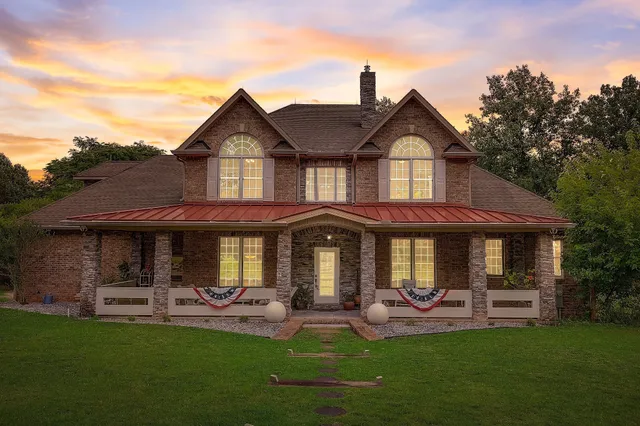 a front view of a house with a garden and porch