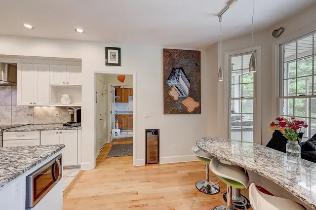 a living room with stainless steel appliances kitchen island granite countertop furniture and a kitchen view