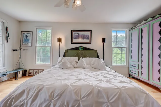 a bedroom with a large bed and a large window
