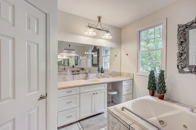 a bathroom with a sink a large mirror and a shower