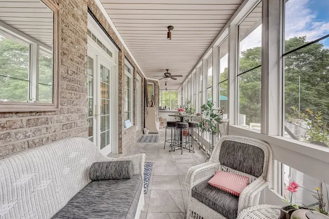 a view of a patio with couches chairs and a yard
