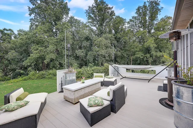 a view of an outdoor sitting area with furniture and backyard