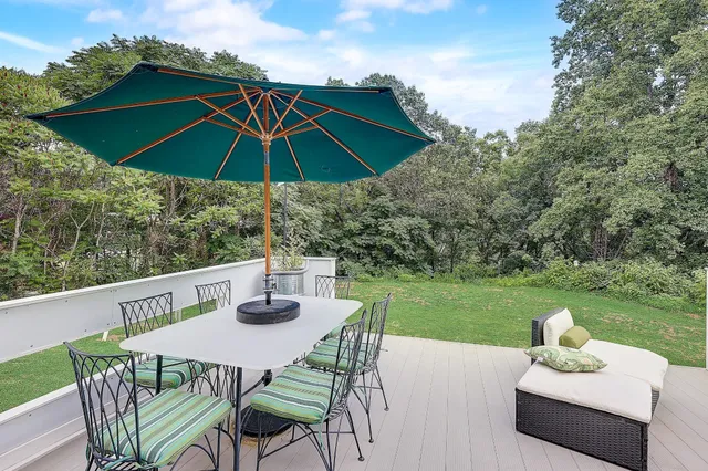 a view of a patio with couches table and chairs and potted plants