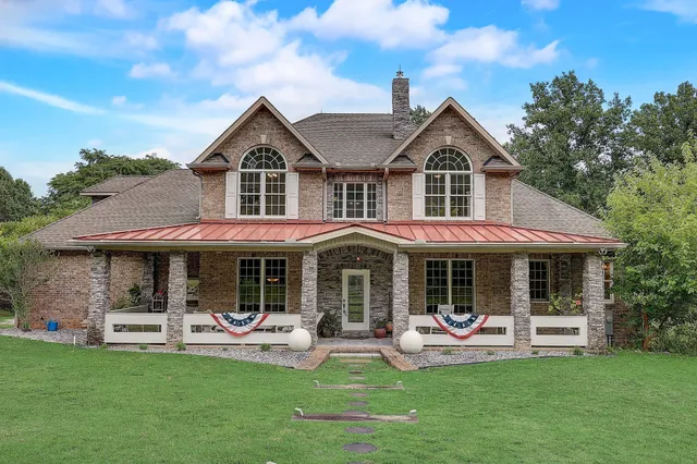 a front view of a house with a garden and porch