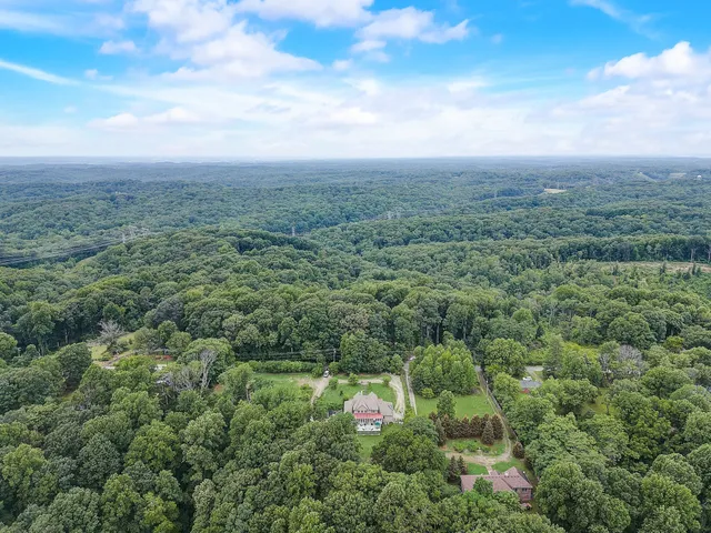 a front view of house with yard seating and green space