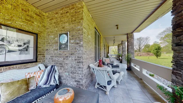 a balcony with furniture and a potted plant
