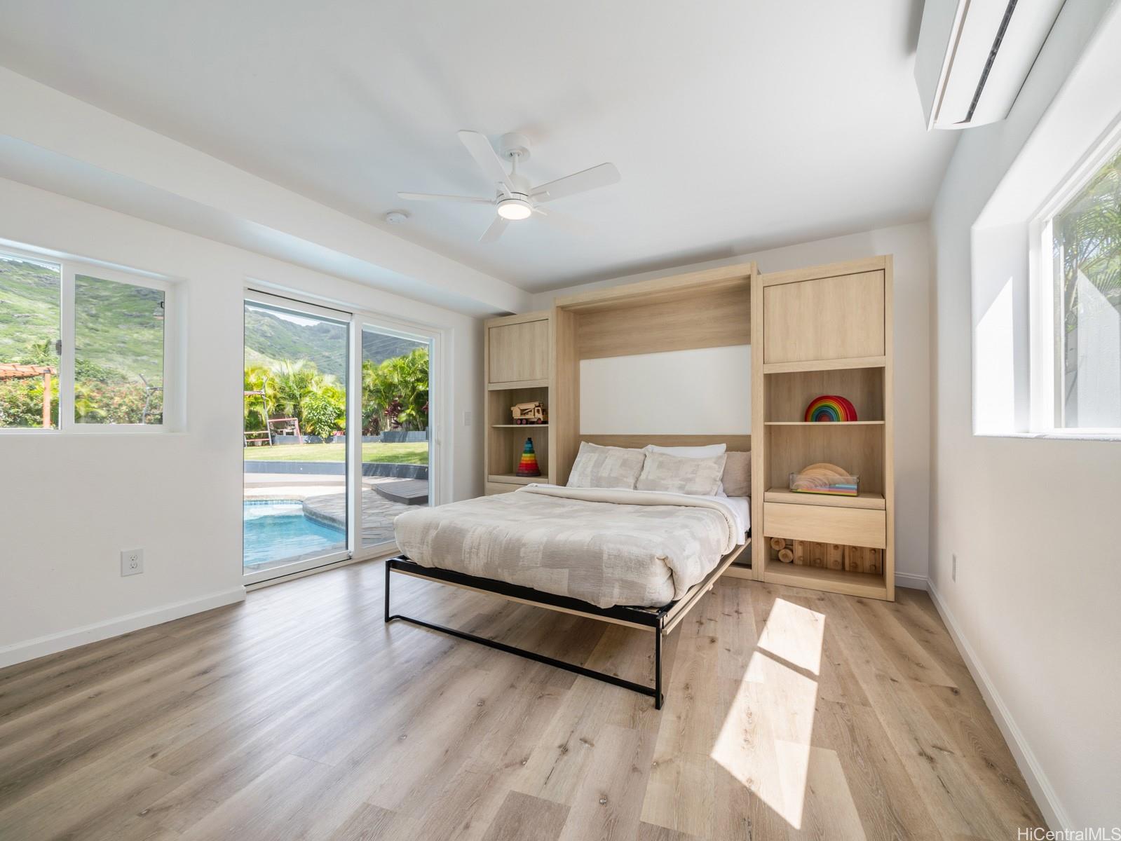 6815 Niumalu Loop Honolulu, HI 96825 - Photo 14 of 25 Ground Floor Bedroom #1 Murphy Bed and storage looks out onto Pool Deck