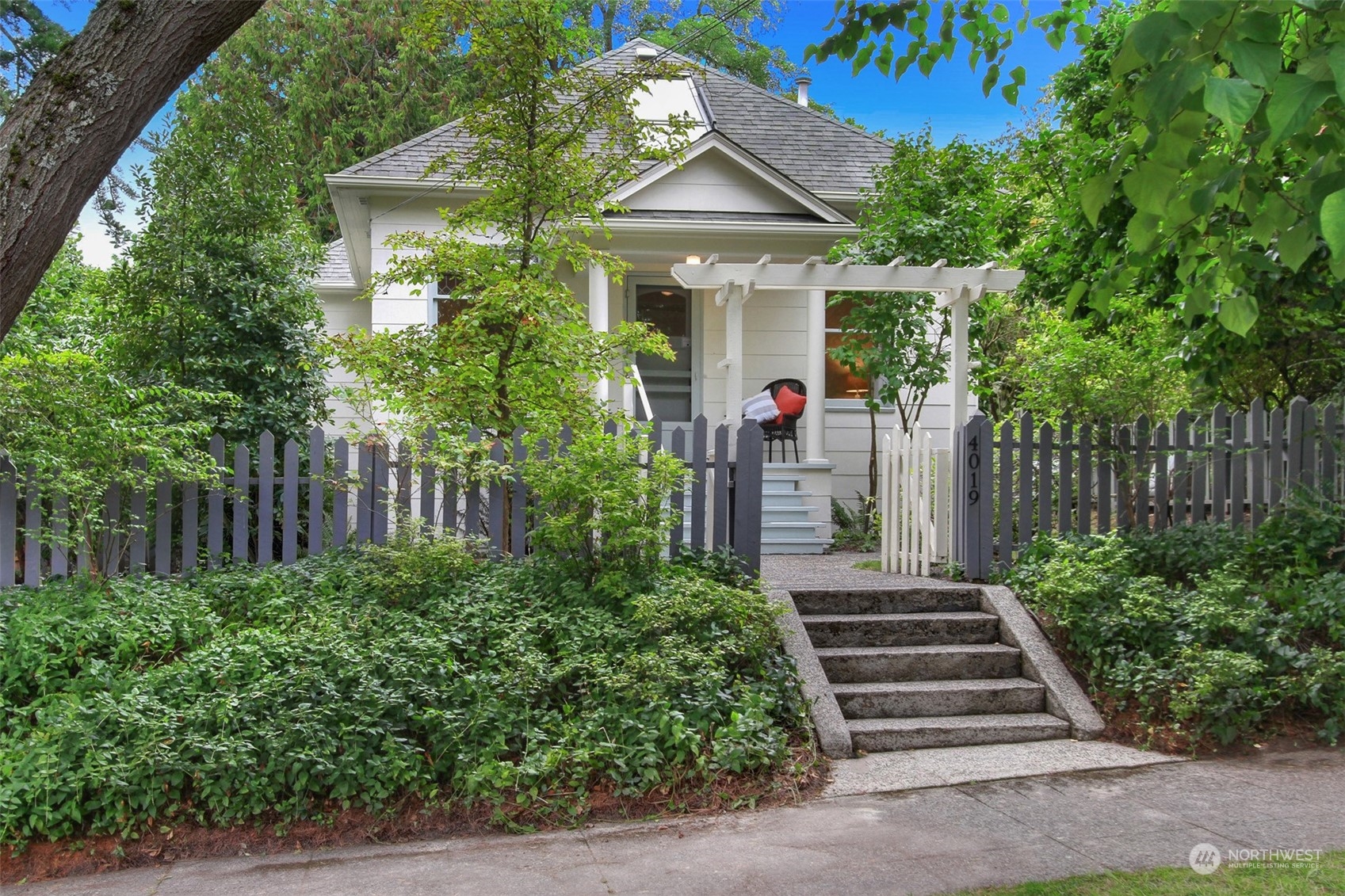 a front view of a house with a yard and plants