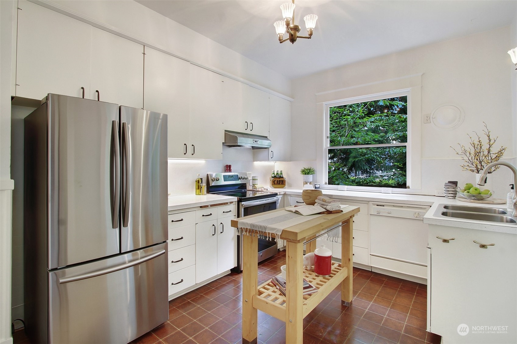 4019 Sunnyside Avenue North Seattle, WA 98103 - Photo 11 of 22 a kitchen with stainless steel appliances a stove a sink and a refrigerator