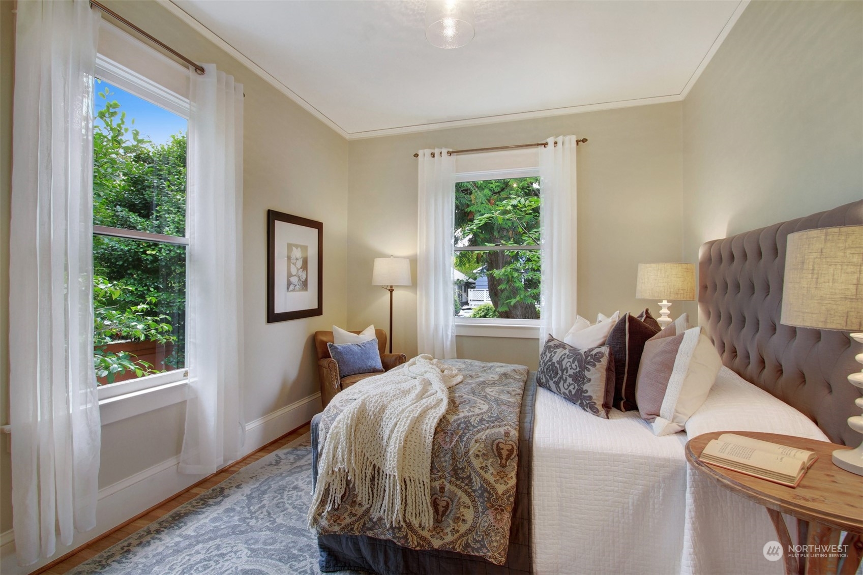 4019 Sunnyside Avenue North Seattle, WA 98103 - Photo 9 of 22 a bedroom with a bed and wooden floor