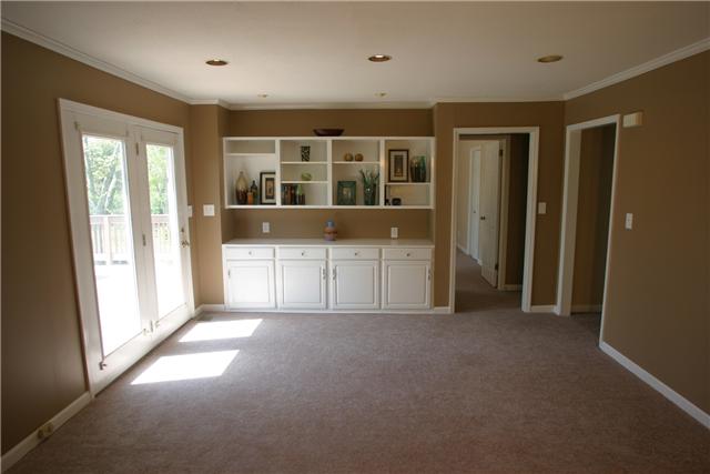 7309 Cavalier Road Nashville, TN 37221 - Photo 6 of 20 Den w/ Built in Cabinetry and French Door to the Deck