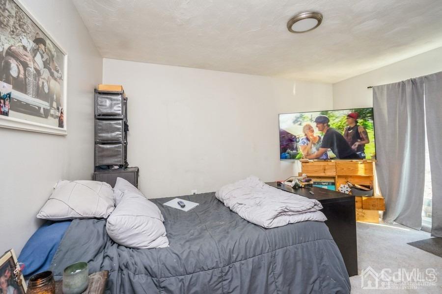 121 Winthrop Road Edison, NJ 08817 - Photo 14 of 16 a bedroom that has a bed and a chair in it